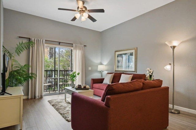 living room featuring light hardwood / wood-style floors and ceiling fan