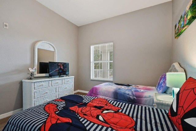 bedroom featuring lofted ceiling