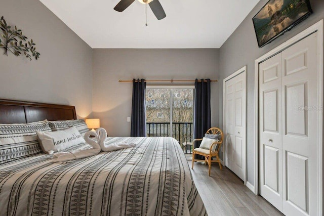 bedroom with access to exterior, light wood-type flooring, two closets, and ceiling fan