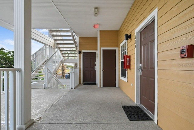 view of exterior entry featuring covered porch