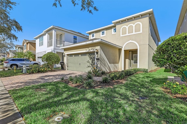 view of front of house featuring a balcony, a garage, and a front lawn