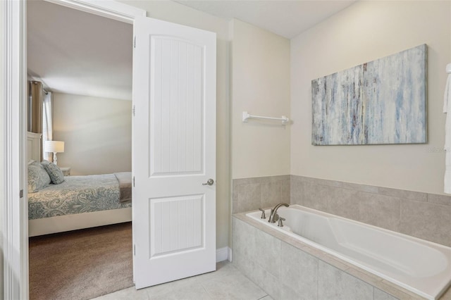 bathroom featuring tile patterned floors and tiled bath