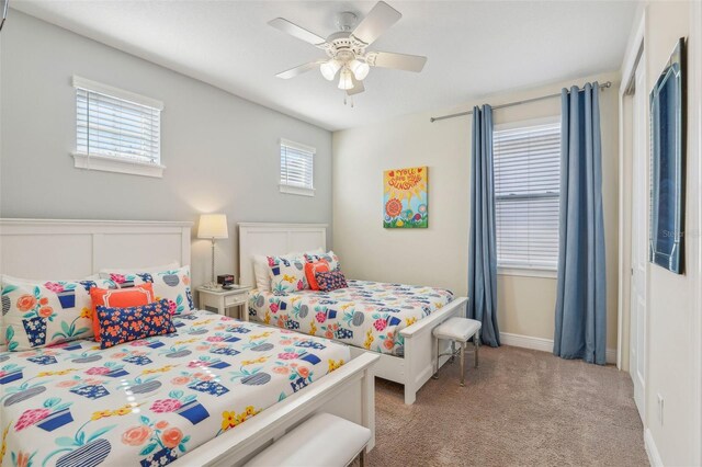 carpeted bedroom with ceiling fan