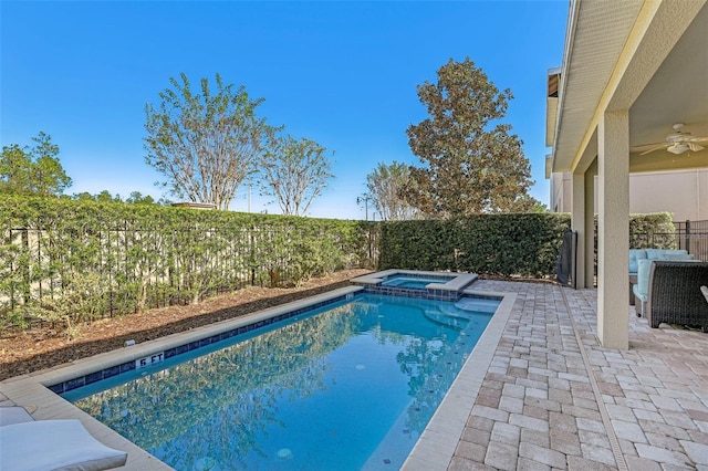 view of swimming pool featuring ceiling fan, a patio, and an in ground hot tub