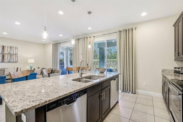 kitchen with appliances with stainless steel finishes, a kitchen island with sink, a healthy amount of sunlight, and sink