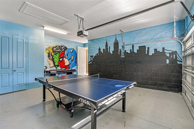 game room with a textured ceiling