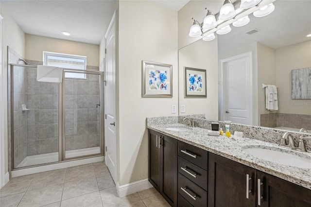 bathroom featuring tile patterned flooring, vanity, and an enclosed shower