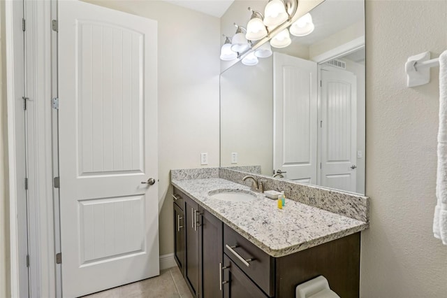 bathroom with vanity, tile patterned floors, and a notable chandelier