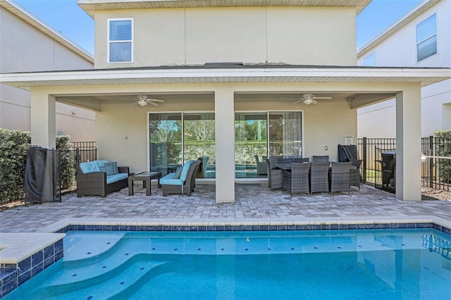 back of property featuring outdoor lounge area, ceiling fan, and a patio