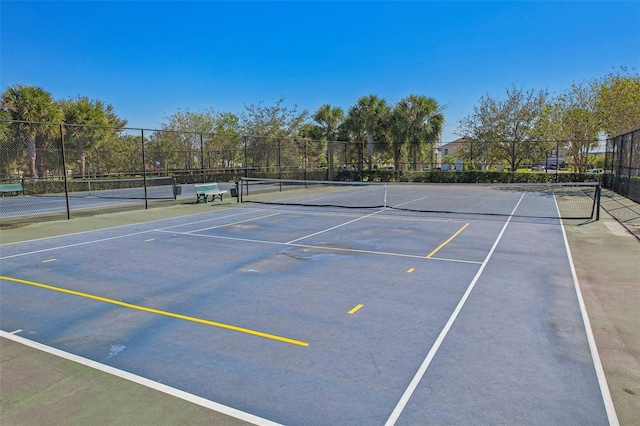 view of sport court with basketball hoop