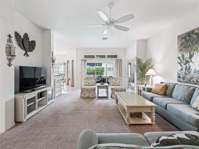 carpeted living room featuring ceiling fan