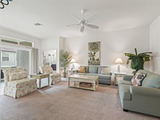 living room featuring ceiling fan and light colored carpet