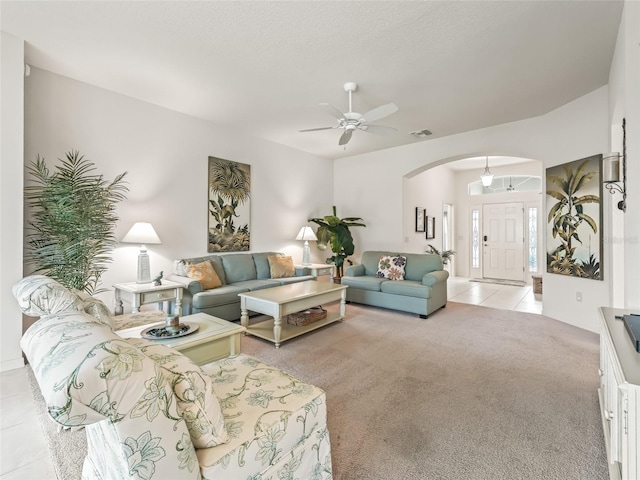 carpeted living room with ceiling fan