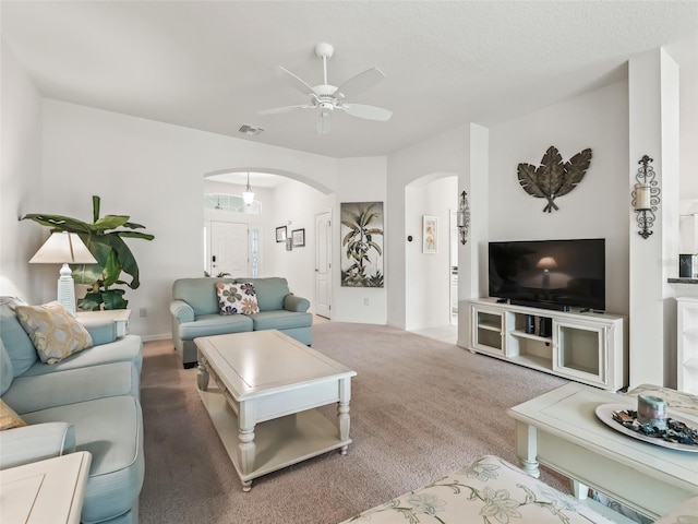 living room with ceiling fan and carpet floors