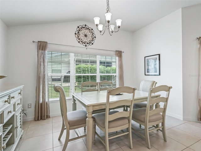 tiled dining area featuring a chandelier and vaulted ceiling