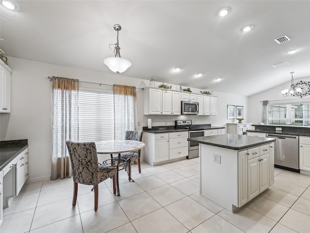 kitchen featuring pendant lighting, stainless steel appliances, white cabinetry, and plenty of natural light