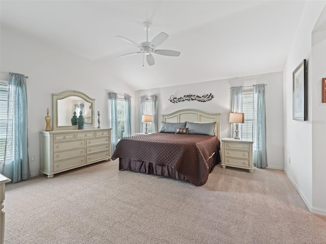 bedroom featuring ceiling fan, lofted ceiling, and multiple windows