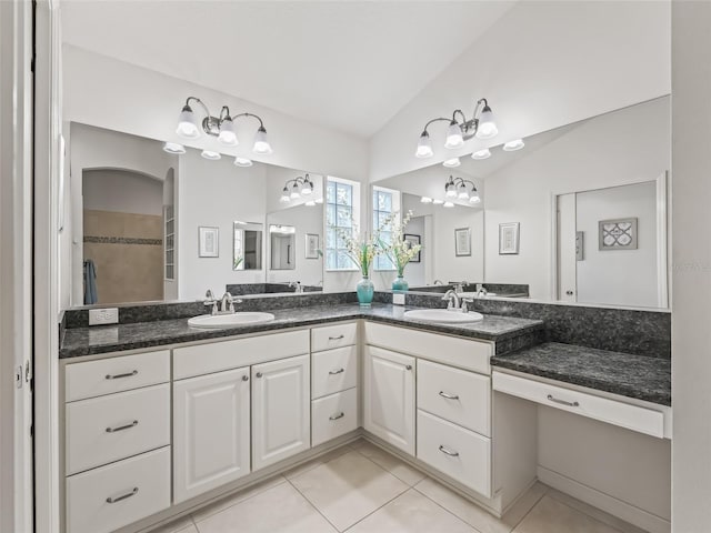 bathroom featuring tile patterned floors, vanity, and lofted ceiling