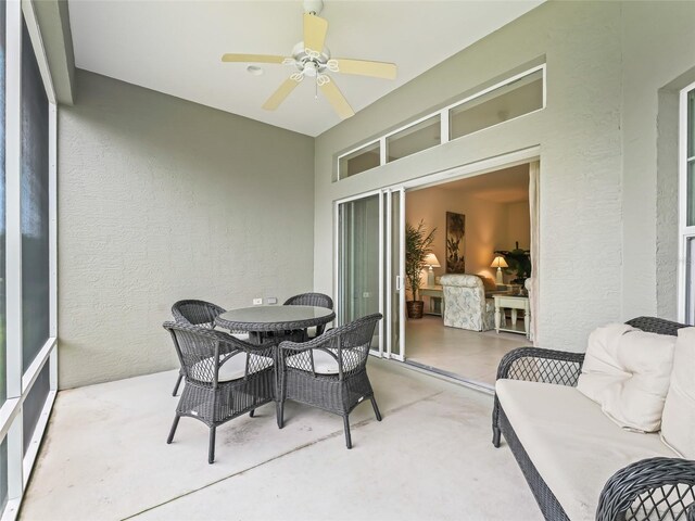 sunroom featuring ceiling fan