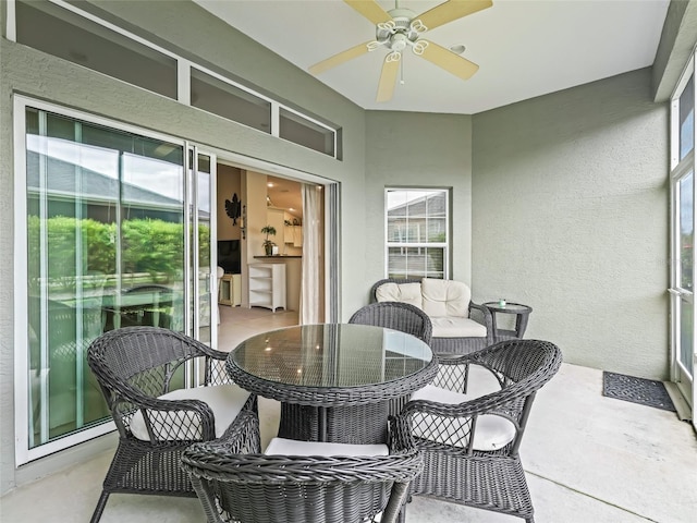 sunroom featuring ceiling fan