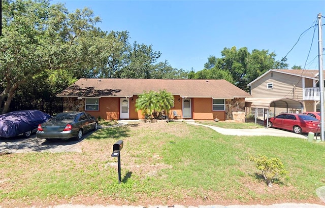 single story home with a carport and a front lawn