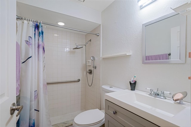 bathroom with vanity, curtained shower, and toilet