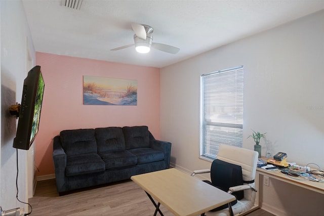 home office featuring light hardwood / wood-style floors and ceiling fan