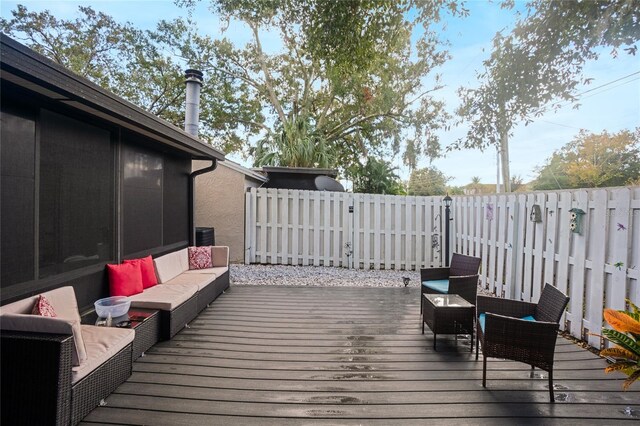 wooden terrace with an outdoor living space