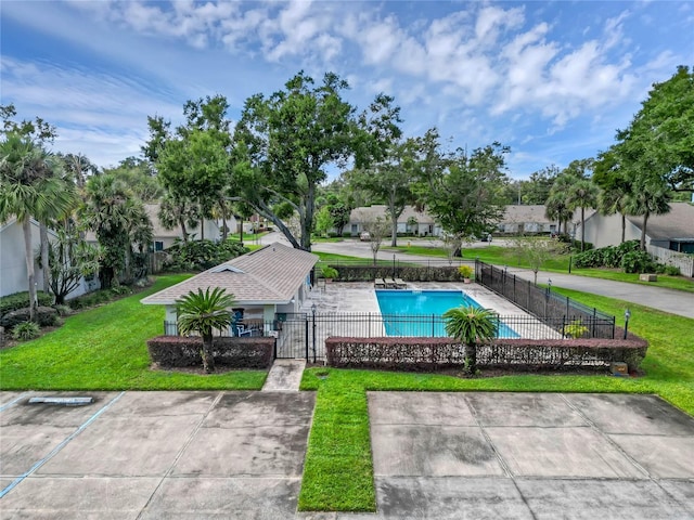 view of swimming pool featuring a patio area and a yard