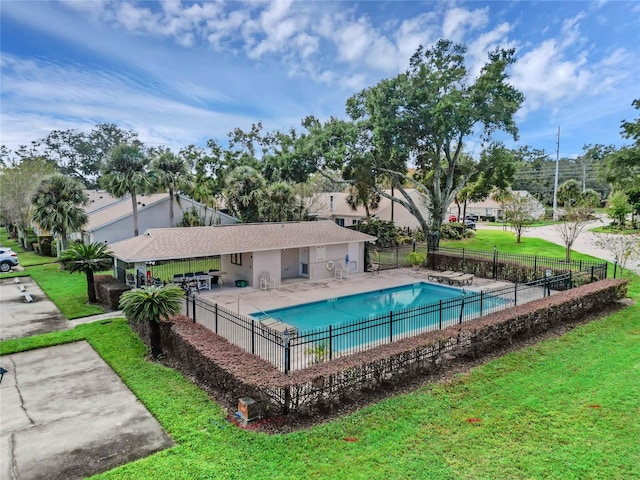 view of swimming pool with a yard and a patio