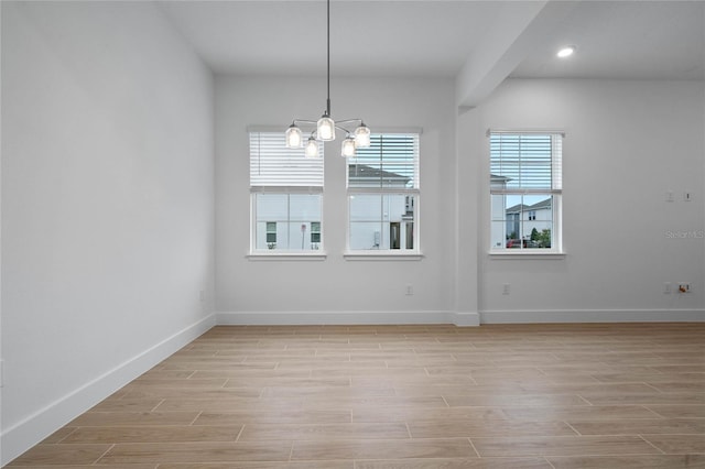 unfurnished dining area with an inviting chandelier