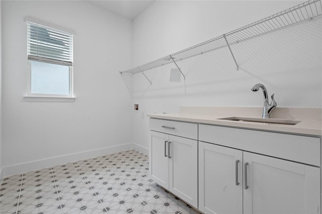 washroom featuring cabinets, hookup for a washing machine, and sink