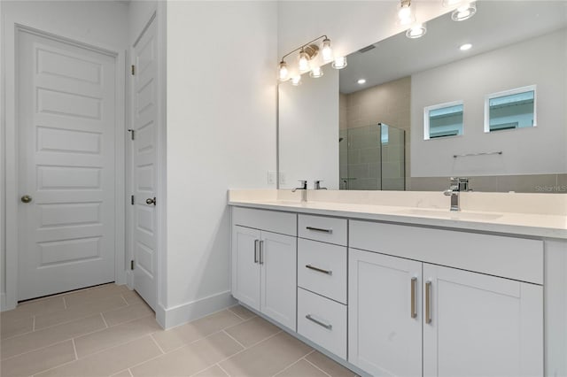 bathroom with vanity, tile patterned floors, and walk in shower