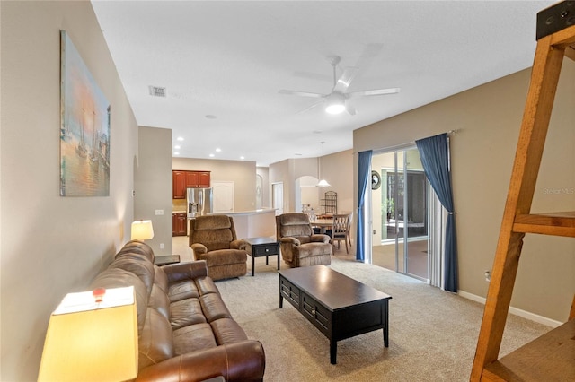 carpeted living room featuring ceiling fan