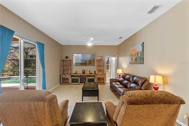 living room featuring a textured ceiling and ceiling fan