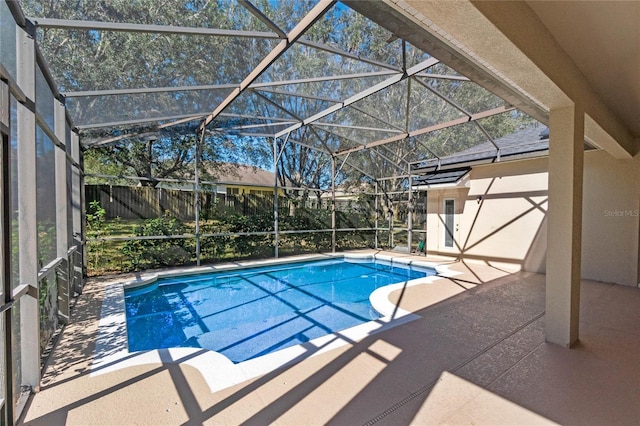 view of swimming pool featuring a lanai and a patio