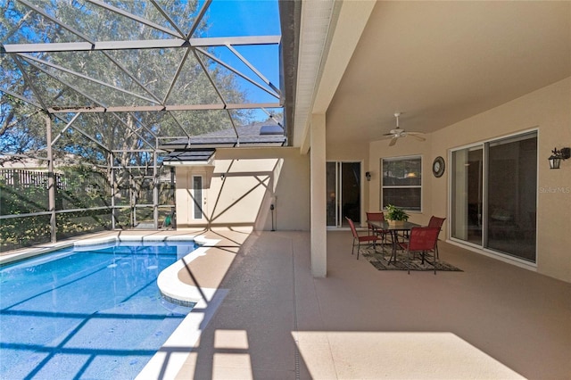 view of pool with a lanai, ceiling fan, and a patio