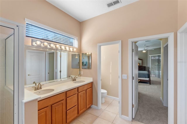 bathroom featuring ceiling fan, tile patterned floors, toilet, and vanity