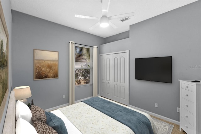 carpeted bedroom with a closet and ceiling fan