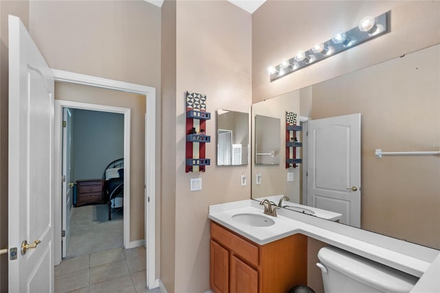 bathroom featuring toilet, vanity, and tile patterned floors