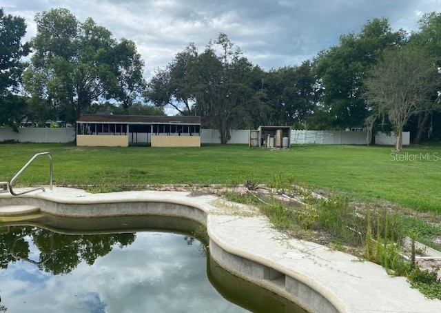 view of pool with a yard