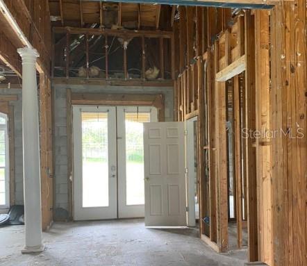 miscellaneous room featuring french doors and decorative columns