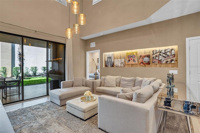 tiled living room featuring a high ceiling