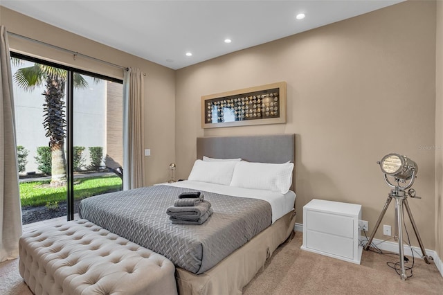 bedroom featuring access to exterior and light carpet