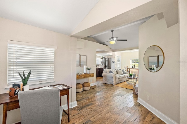 living room featuring ceiling fan, wood-type flooring, and lofted ceiling