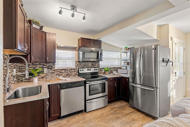 kitchen with sink, stainless steel appliances, tasteful backsplash, light hardwood / wood-style flooring, and dark brown cabinets