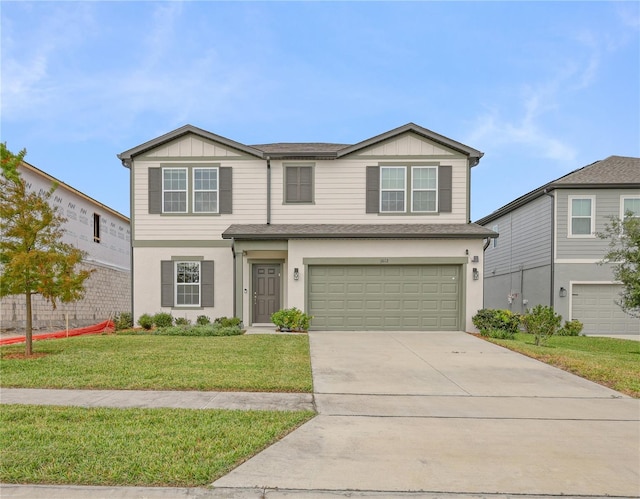 view of front of home with a front yard and a garage