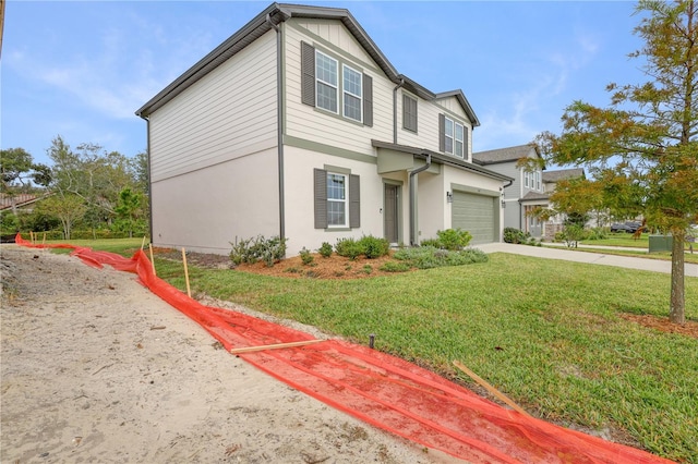 view of front of house with a front yard and a garage