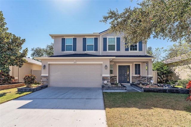 view of front of home featuring a garage and a front lawn