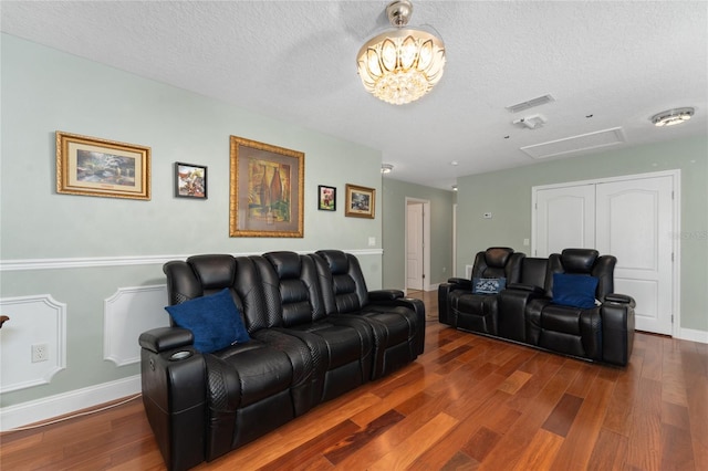 living room with dark hardwood / wood-style flooring and a textured ceiling